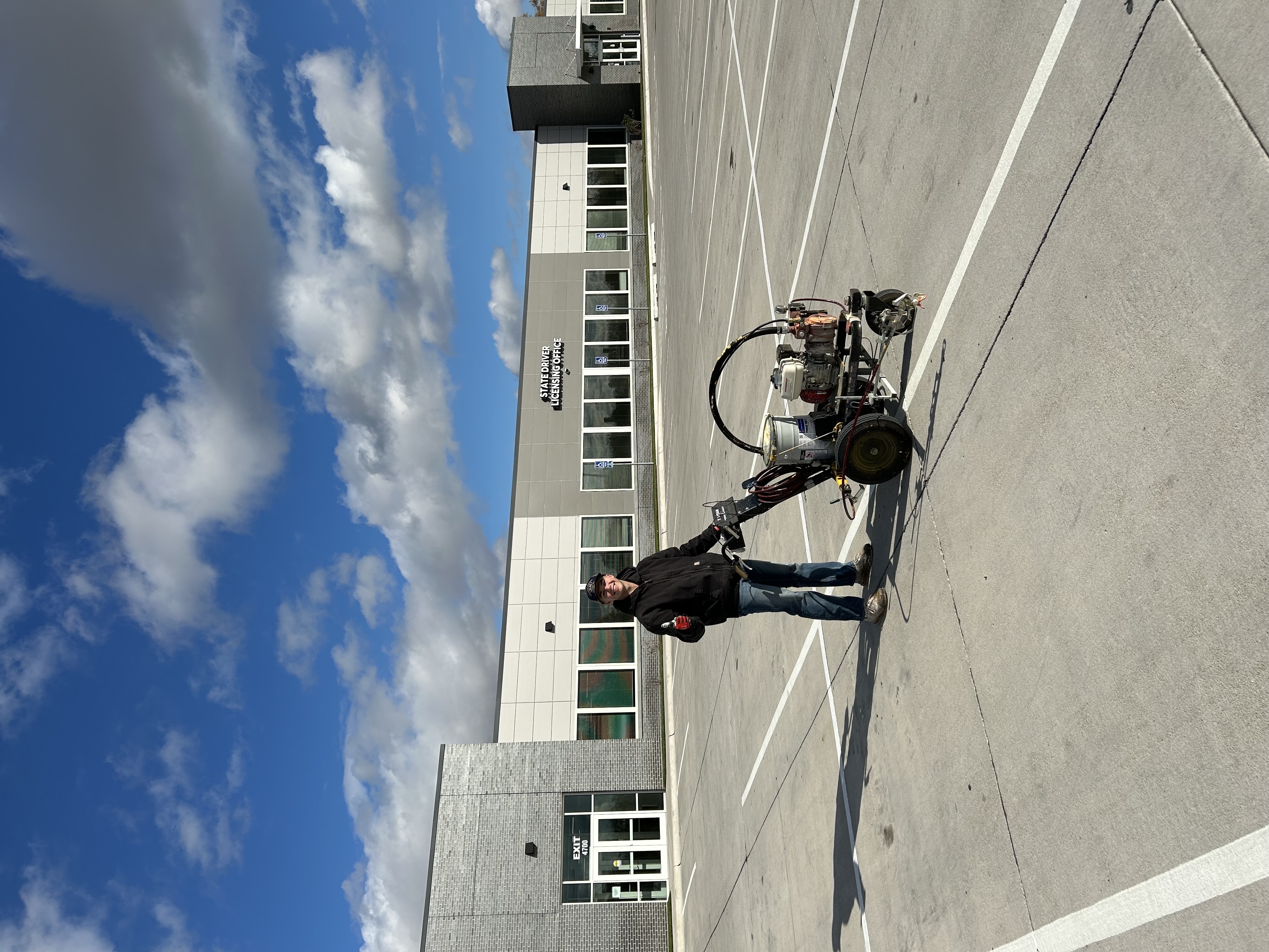 Karter Otte with line striping equipment at the State Driver Licensing Office
