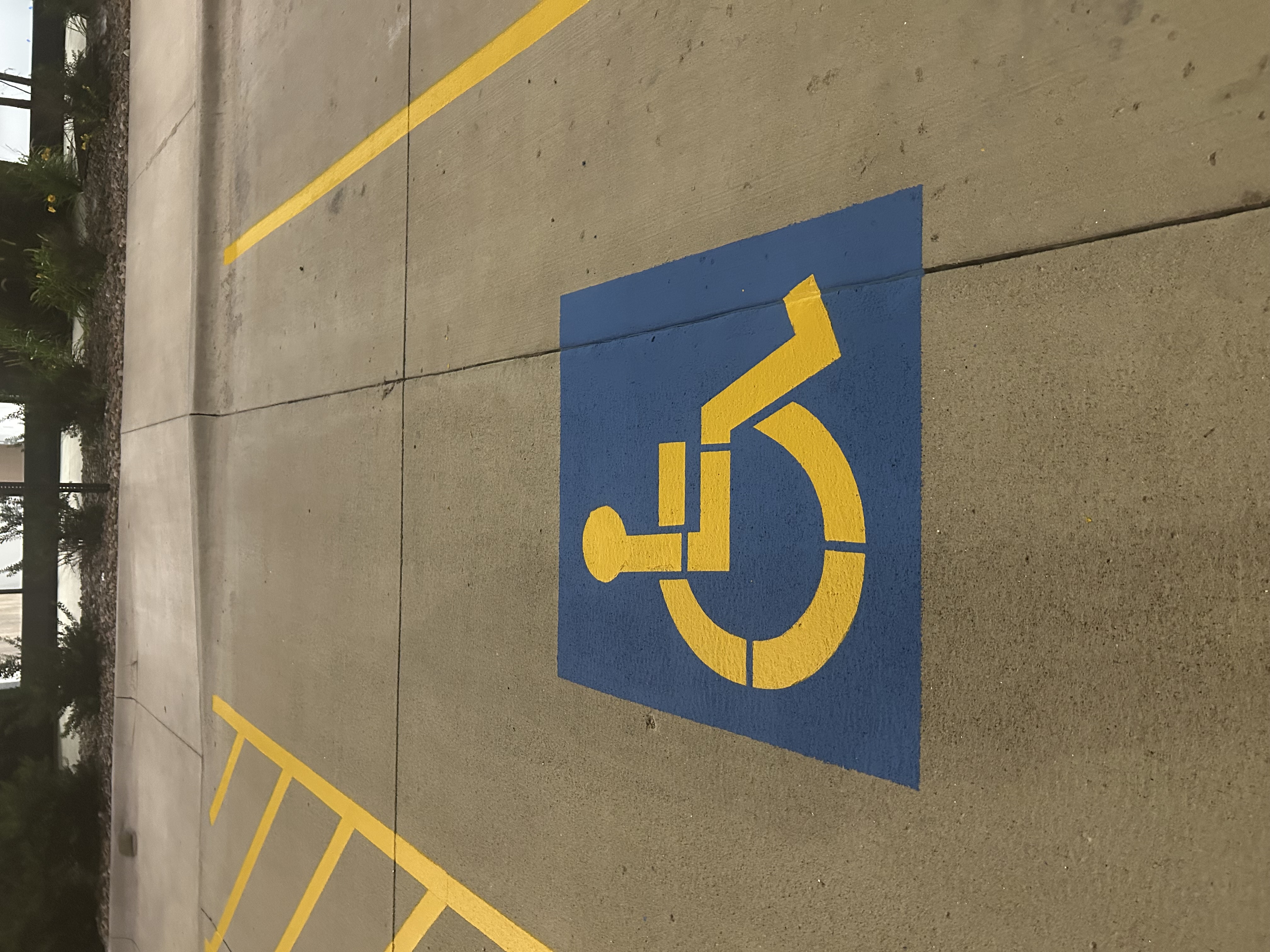 ADA handicap stencil close-up in blue and yellow