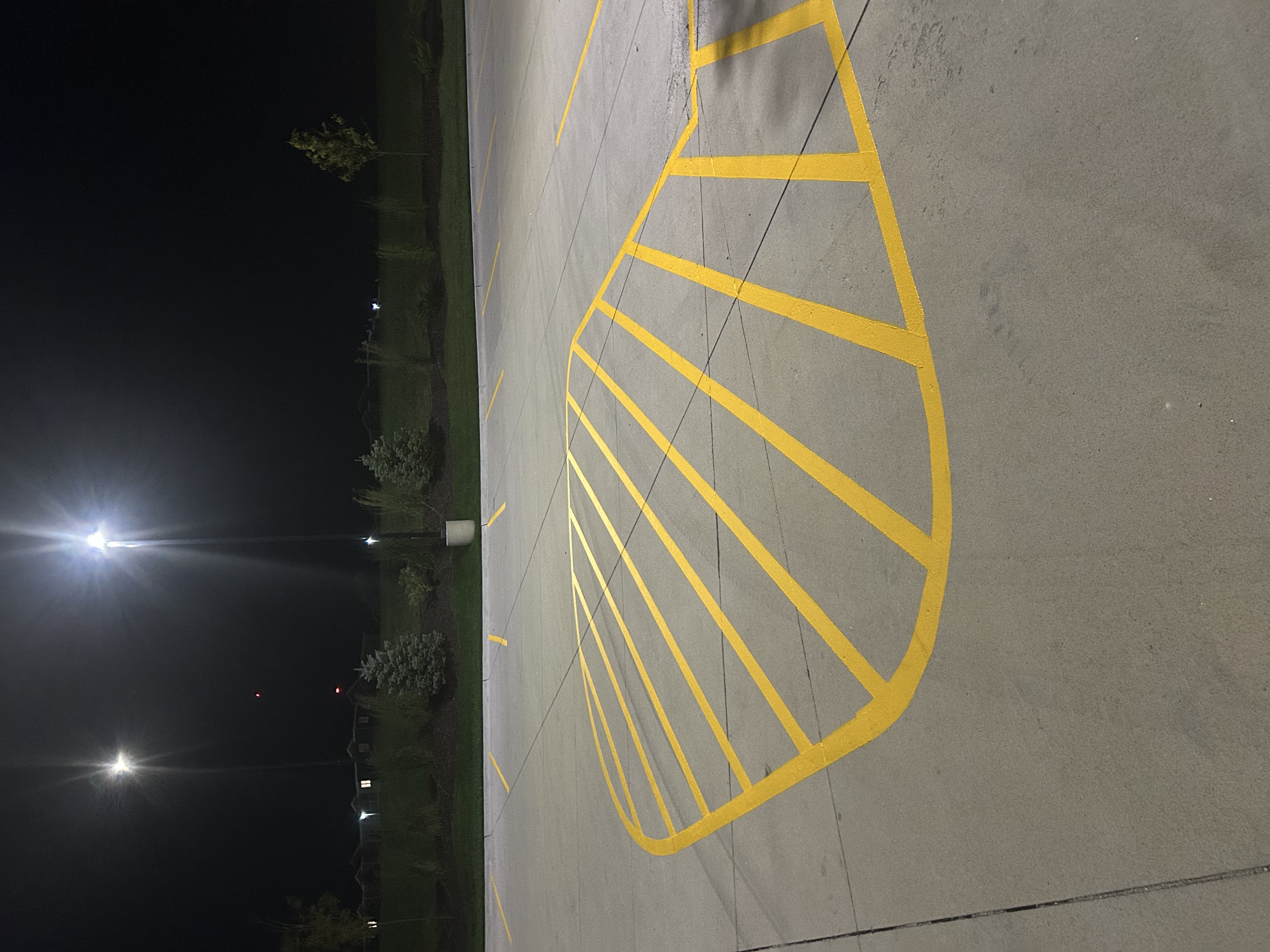 Curved no-parking fan zone striping at night