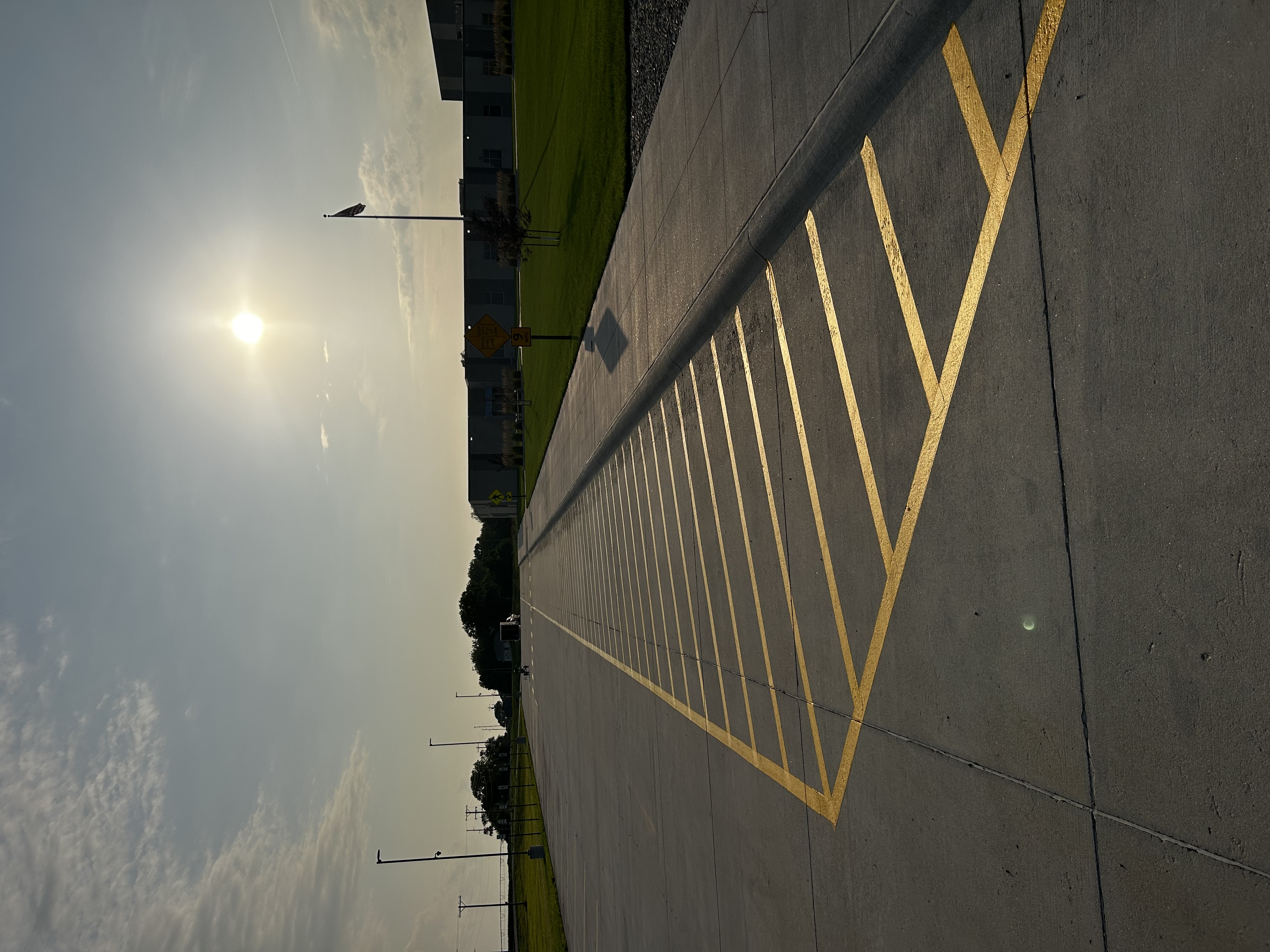 School parking lot with yellow no-parking hatching at sunset