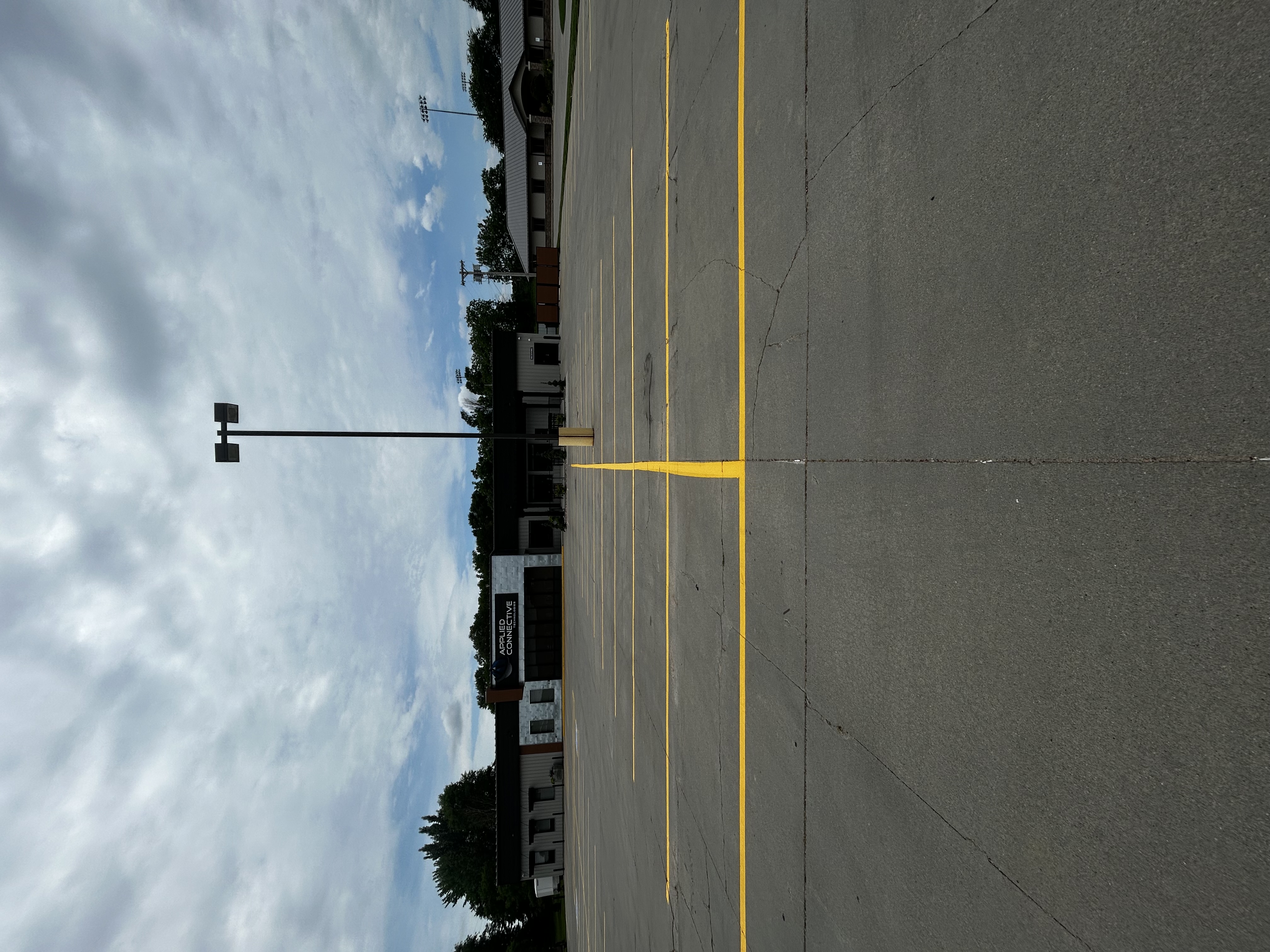 Applied Connective parking lot striping with dramatic clouds