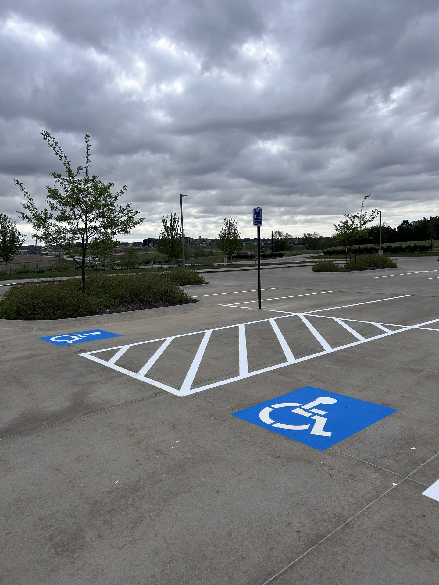Newly striped ADA accessible parking stall with hatched access aisle