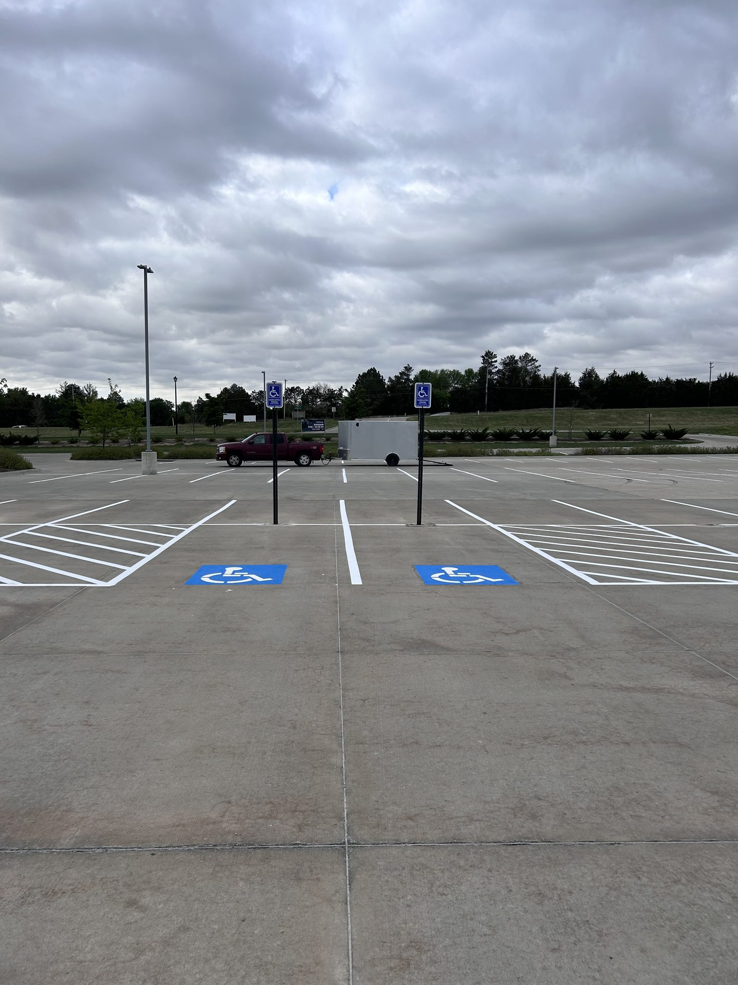 Row of ADA accessible stalls with blue symbols and white hatching
