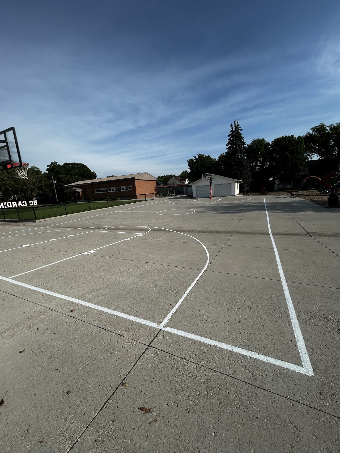 Basketball court lines painted on a concrete surface