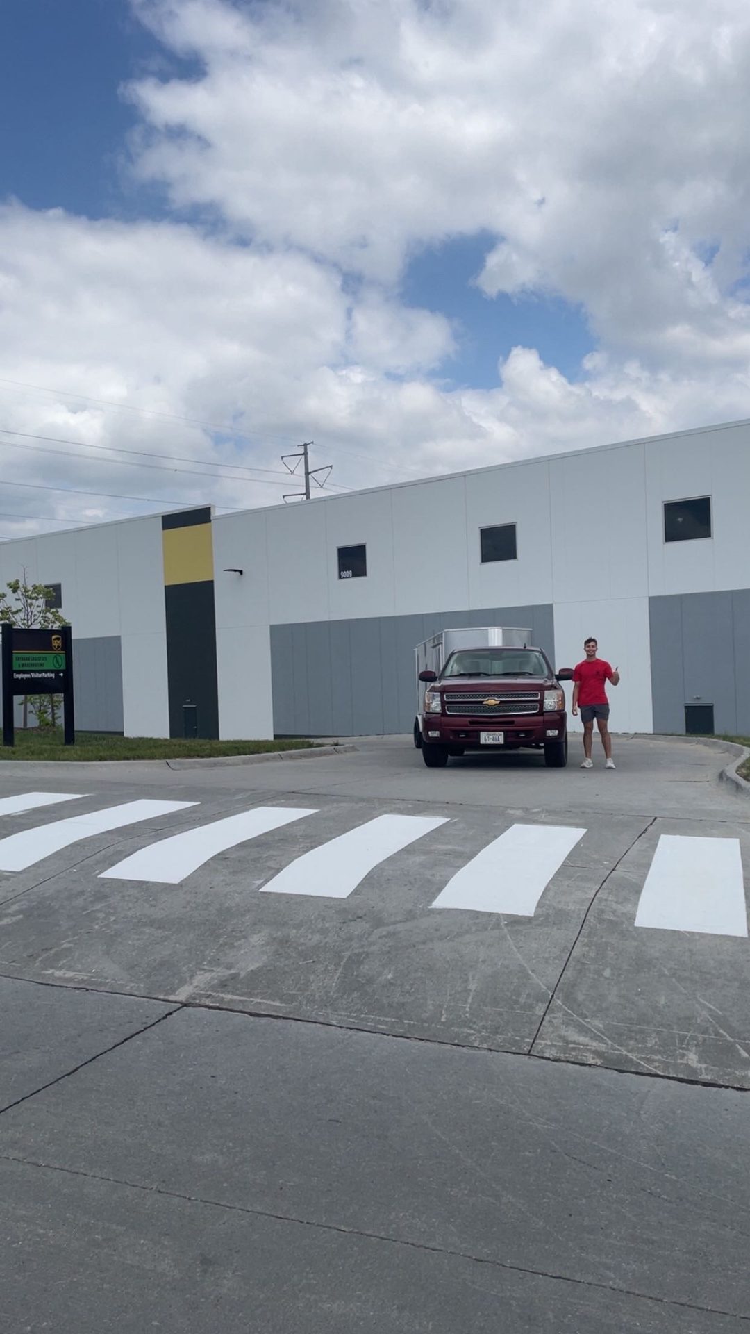 Freshly painted white crosswalk in front of a commercial building