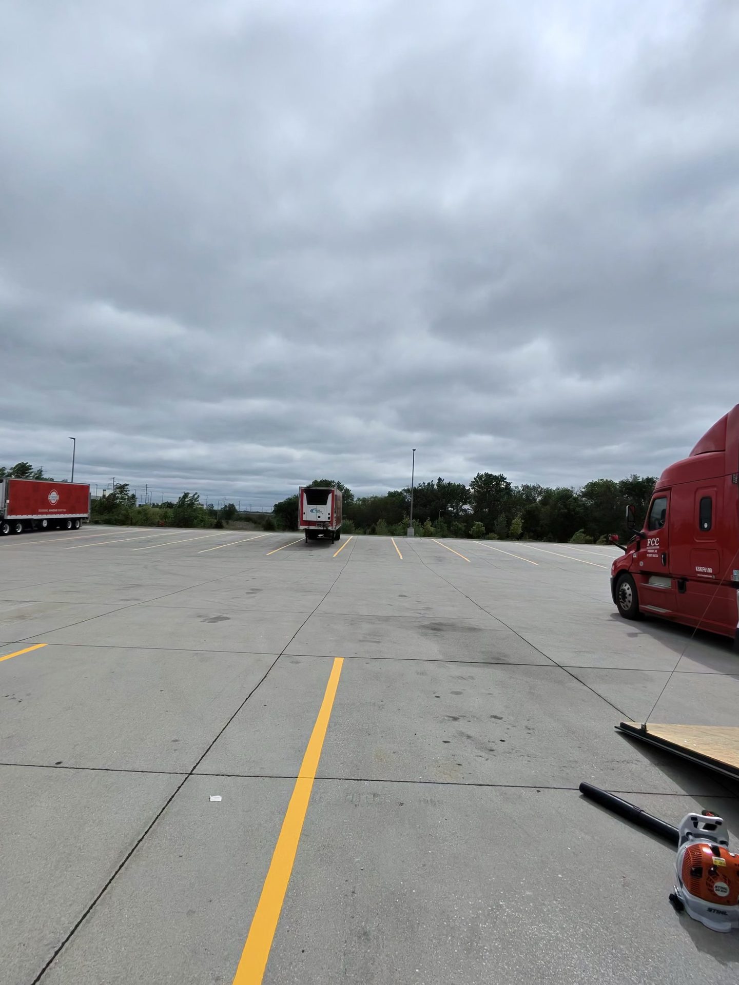 Yellow striping on a truck lot at a warehouse